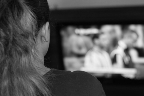 woman sitting watching her television